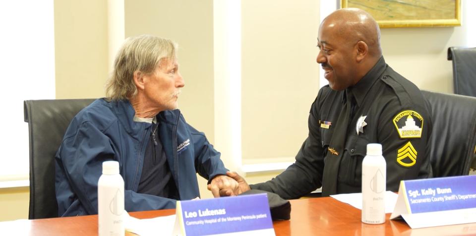 Leo Lukenas (left) and Sgt.  Kelly Bunn (right) shares an emotional moment during a press conference at Montage Health this week.