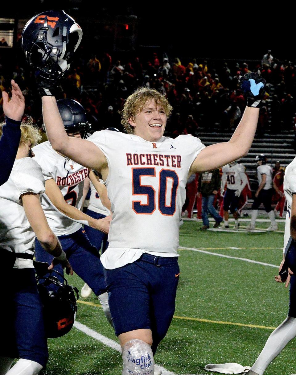Rochester senior offensive lineman and linebacker Parker Lyons raises his arms to celebrate the Rockets' 42-14 Class 4A semifinal victory at Murphysboro on Saturday, Nov. 18, 2023.