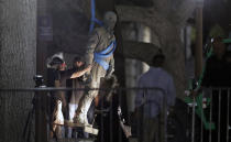 <p>A statue of Confederate Gen. Robert E. Lee is removed from the University of Texas campus, early Monday morning, Aug. 21, 2017, in Austin, Texas. University of Texas President Greg Fenves ordered the immediate removal of statues of Robert E. Lee and other prominent Confederate figures from a main area of campus, saying such monuments have become “symbols of modern white supremacy and neo-Nazism.” (AP Photo/Eric Gay) </p>