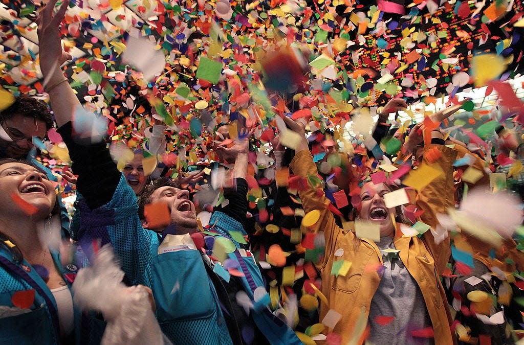 Traders and clerks at the CME Group toss confetti to celebrate the final trading session of the year December 31, 2010