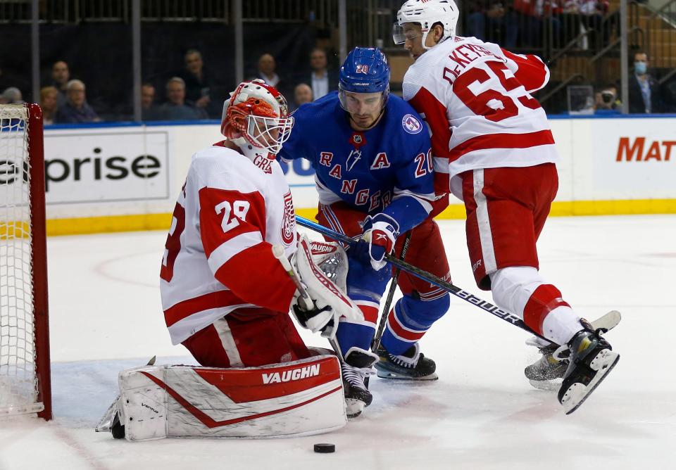 The Rangers' Chris Kreider and Red Wings defenseman Danny DeKeyser work in front of Red Wings goalie Thomas Greiss during the second period on Thursday, Feb. 17, 2022, in New York.