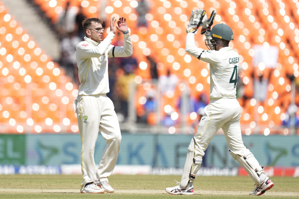 Australia's Todd Murphy, left, celebrate the wicket India's Cheteshwar Pujara with his team player Australia's wicketkeeper Alex Carey during the third day of the fourth cricket test match between India and Australia in Ahmedabad, India, Saturday, March 11, 2023. (AP Photo/Ajit Solanki)