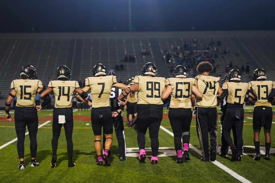 Amado Peña-Gonzalez, No. 99, of Crockett joins his teammates on the field before last week's win over Northeast at Burger Stadium. He has helped the playoff-bound Cougars go 6-3 entering Friday's game against LBJ. He also has undergone an impressive transformation in more ways than one and will play college football next year.