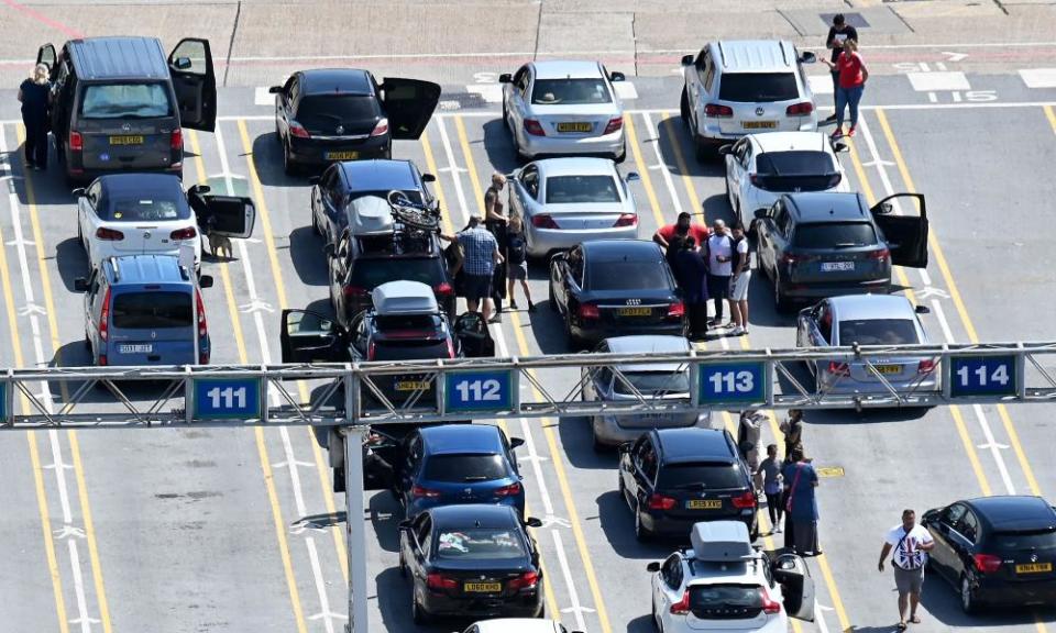 Passengers wait with their vehicles on the quayside to board a cross-channel ferry at Dover.