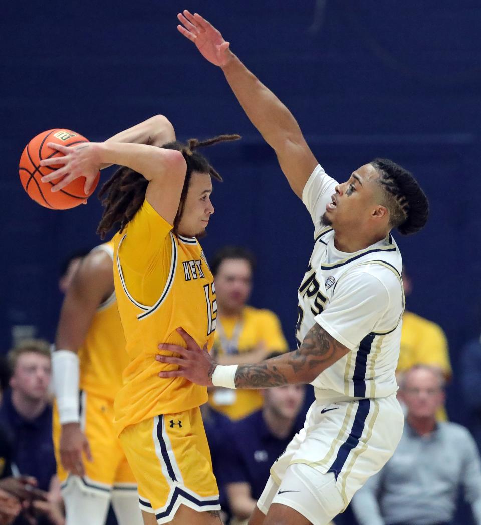 Kent State Golden Flashes guard Jalen Sullinger (13) attempts to pass against Akron Zips guard Greg Tribble (2) during the second half of an NCAA college basketball game, Friday, Feb. 23, 2024, in Akron, Ohio.