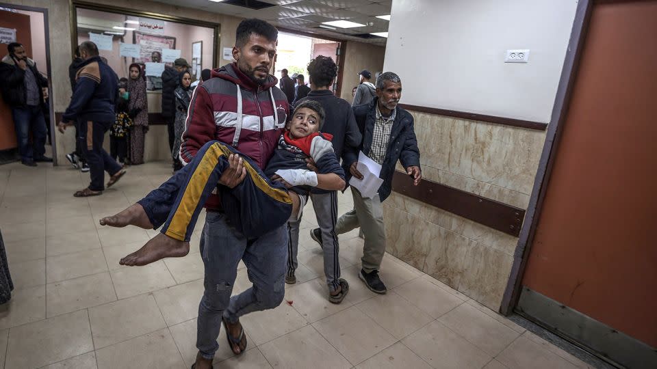 A wounded teen carried into Al-Aqsa Martyrs Hospital following Israeli attacks on Deir al-Balah in Gaza on January 4, 2024. - Ali Jadallah/Anadolu/Getty Images