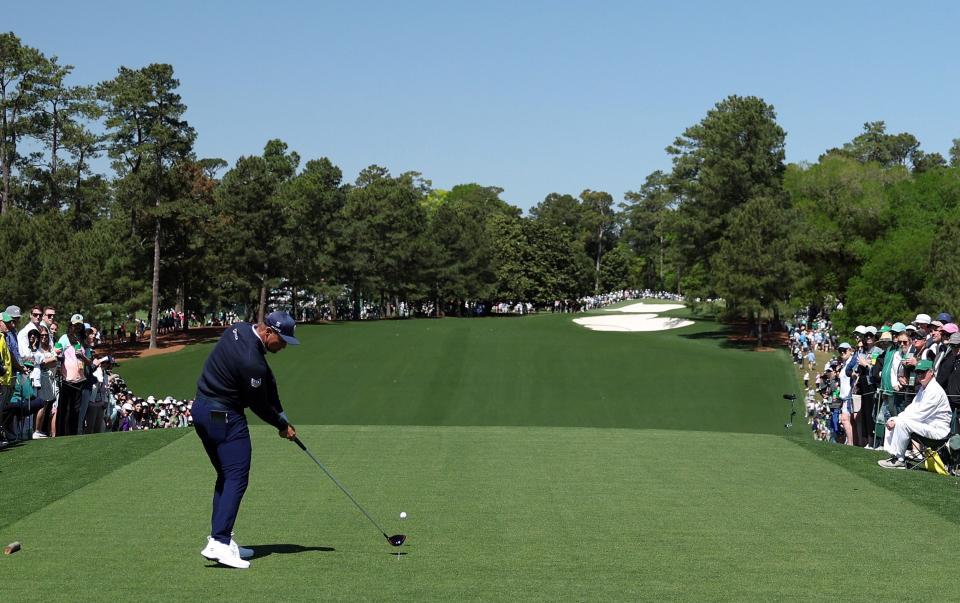 Bryson DeChambeau of the United States plays his shot from the first tee