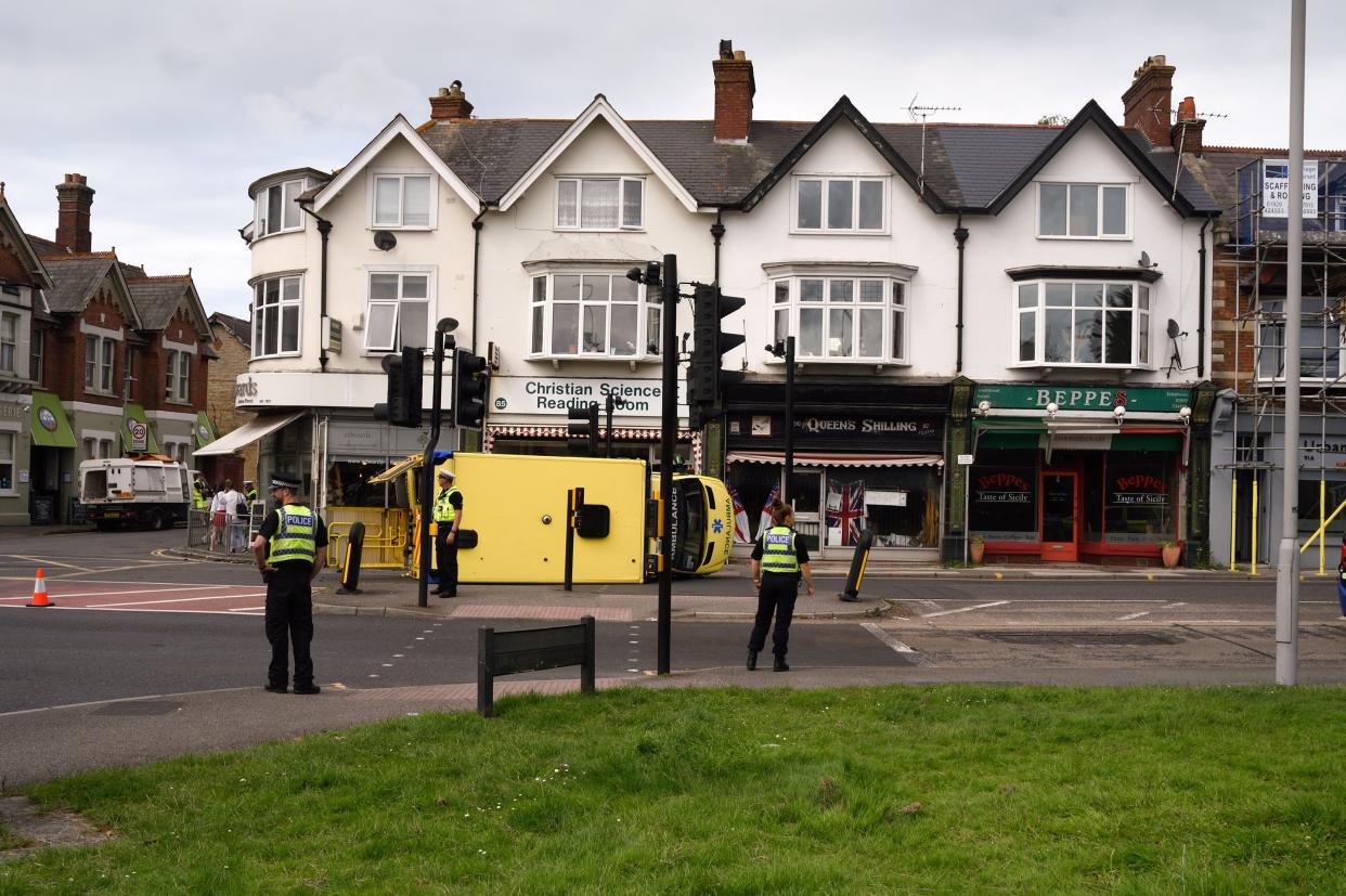 Emergency services are attending a 'serious' crash involving an ambulance and a car in Commercial Road at Ashley Cross which left the ambulance on its side, July 9 2021. See SWNS story SWBRambulance