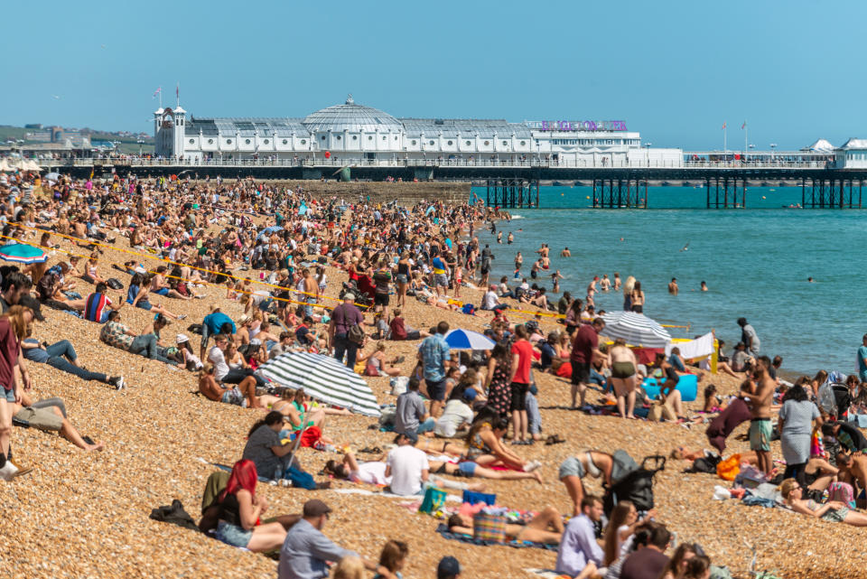 BRIGHTON, ENGLAND - JUNE 22: Crowds enjoy the warm weather on the beach on June 22, 2019 in Brighton, England. Temperatures in south-east England are set to soar with thunderstorm warnings in place for early next week. (Photo by Andrew Hasson/Getty Images)