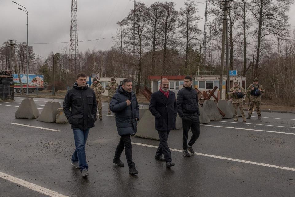 PHOTO: Hadi Nasser Al-Hajri (C-R), Qatari ambassador to Ukraine, and Ukrainian Human Rights Commissioner Dmytro Lubinets (C-L) walk past Ukrainian border guards standing at the border of Ukraine and Belarus, on Feb. 20, 2024. (Roman Pilipey/AFP via Getty Images)