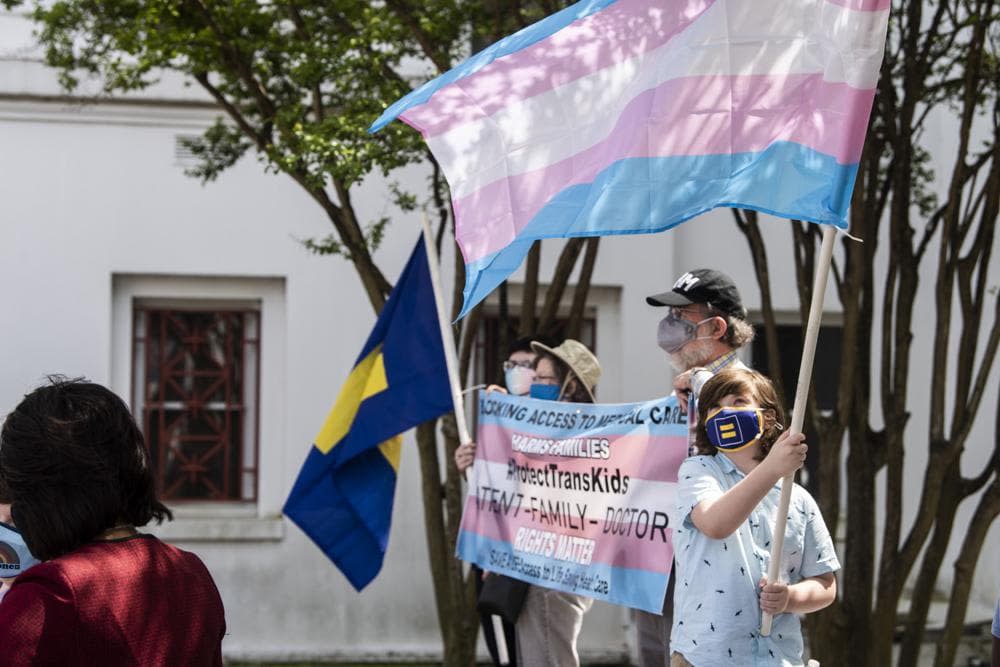 Protestors in support of transgender rights rally outside the Alabama State House in Montgomery, Ala., on Tuesday, March 30, 2021. (Jake Crandall/The Montgomery Advertiser via AP)