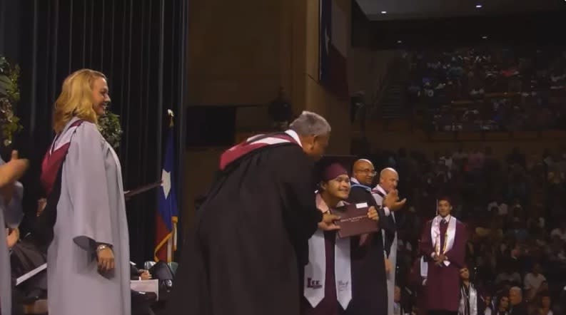 Carlos Neira enthusiastically accepts his high school diploma to a wave of cheers. (Photo: Facebook)