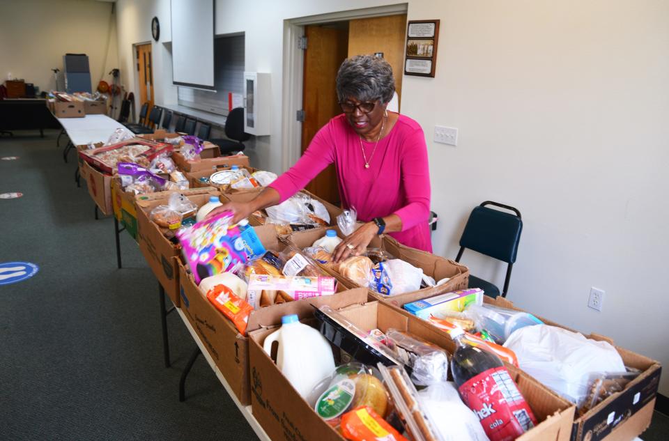 Lanette Hamilton prepares boxes of food. The Metropolitan Missionary Baptist Church Outreach Program in Cocoa feeds hundreds of people every week. The group is a finalist for the Organization of the Year.