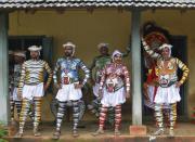 Dancers in body paint wait to take part in a performance during the festivities marking the start of the annual harvest festival of "Onam" in the southern Indian city of Kochi September 7, 2013. The ten-day-long festival is celebrated annually in India's southern coastal state of Kerala to commemorate the return of King Mahabali to meet his beloved subjects. (REUTERS/Sivaram V)