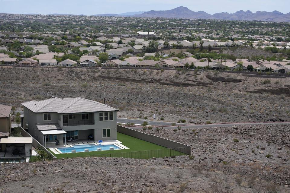 Water officials in the Las Vegas area want to cap the size of new swimming pools like this one at a home abutting desert land in Henderson, Nev. <a href="https://newsroom.ap.org/detail/ColoradoRiverUsersWesternDrought/752a24416a174bcd8bb8fcbaed0a2b9b/photo" rel="nofollow noopener" target="_blank" data-ylk="slk:AP Photo/John Locher;elm:context_link;itc:0;sec:content-canvas" class="link ">AP Photo/John Locher</a>