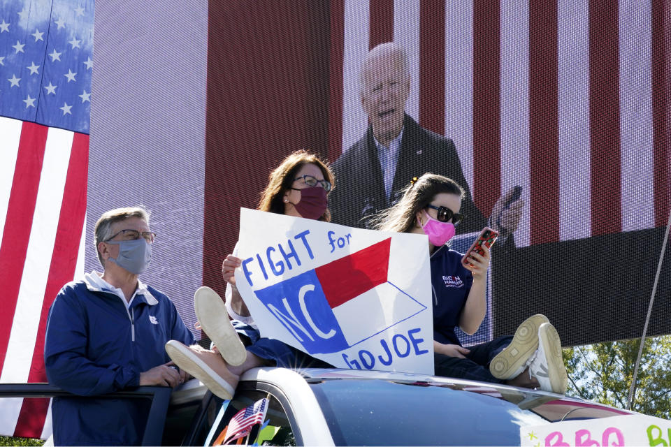 Supporters listen as Democratic presidential candidate former Vice President Joe Biden speaks during a campaign event at Riverside High School in Durham, N.C., Sunday, Oct. 18, 2020. (AP Photo/Carolyn Kaster)