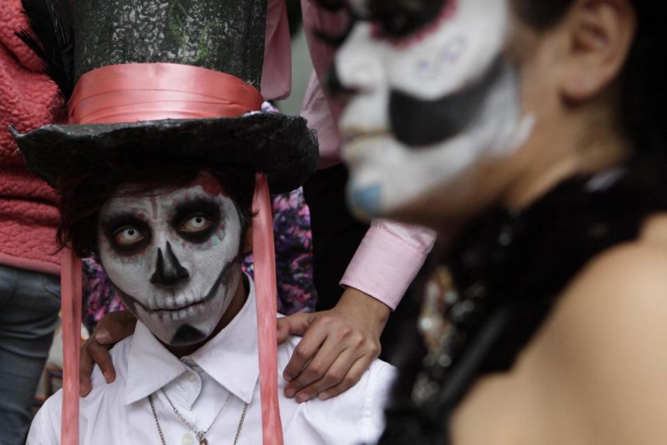 Traditional skull face paint should not be bloody or scary, but rather festive (Anita Baca / AP)