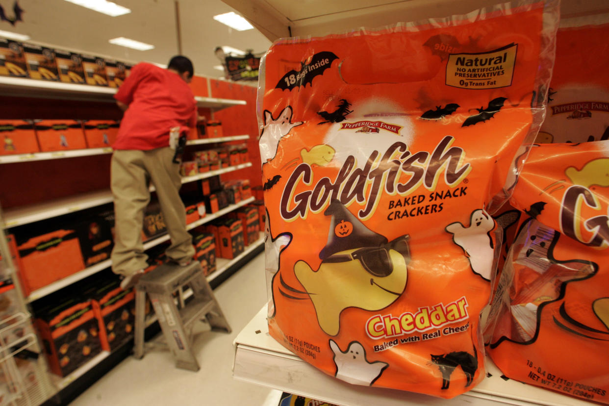Is cheese a treat? Marketers are increasingly pitching healthy foods like pretzels and cheese for Halloween, hoping to get a sales–boost around the holiday as health–conscious parents look for alternatives to candy. Individual bags of Goldfish crackers are being sold as a Halloween snack at the Target, Los Angeles, halloween treats area Oct. 24, 2007. A Target employee stocks in the background.  (Photo by Mel Melcon/Los Angeles Times via Getty Images)