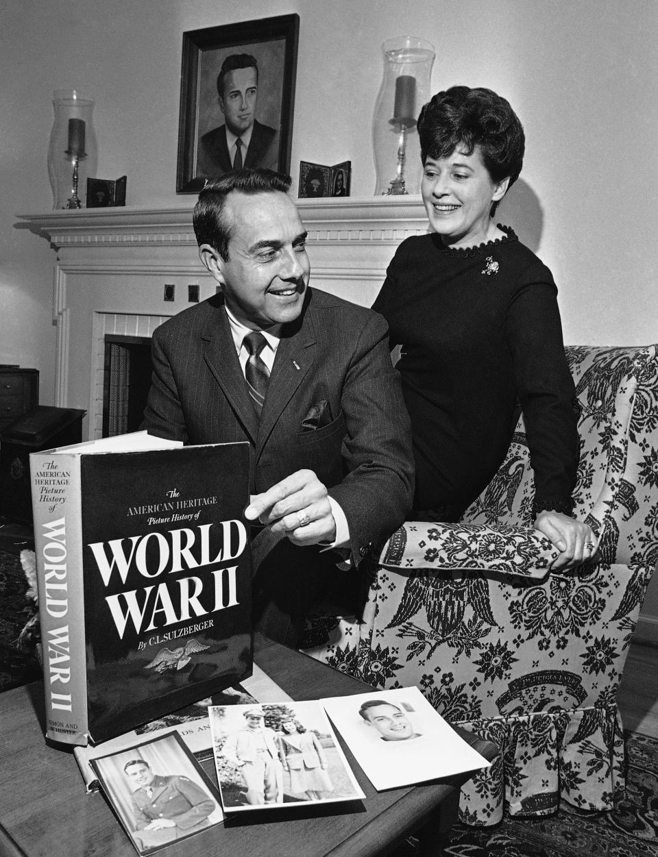 Bob Dole  and his first wife, Phyllis, look at a book about World War II as well as photos of him from his time in the service.
