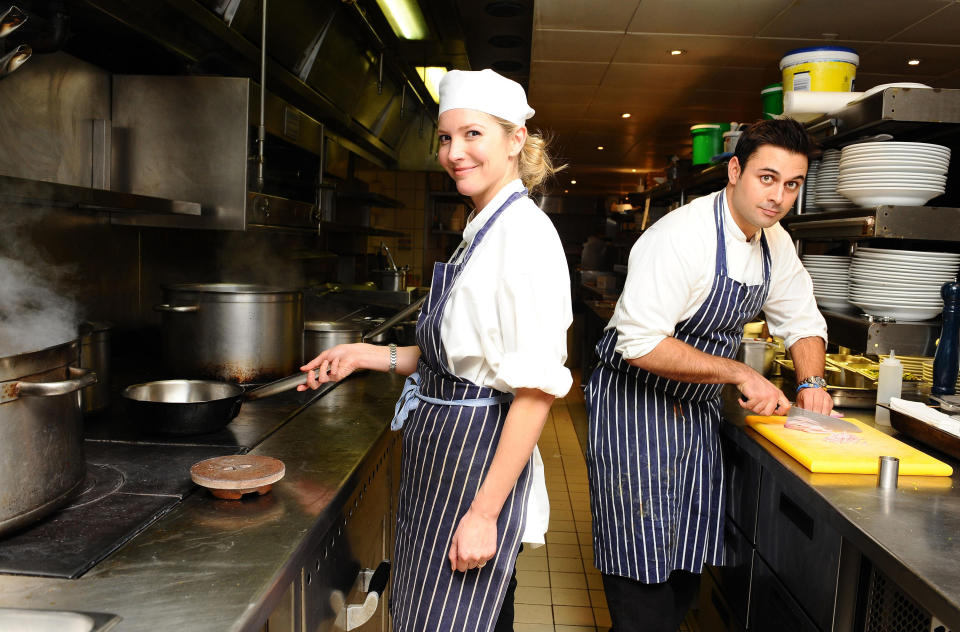 Lisa Faulkner, Celebrity MasterChef winner 2010 and Dhruv Baker, Masterchef winner 2010, cooking at the MasterChef Pop Up restaurant at Meza, Soho.   (Photo by Ian West/PA Images via Getty Images)