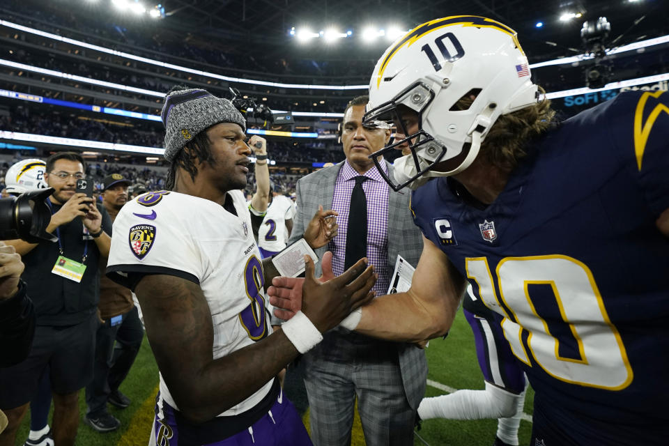 Baltimore Ravens quarterback Lamar Jackson (8) shakes hands with Los Angeles Chargers quarterback Justin Herbert (10) after an NFL football game Sunday, Nov. 26, 2023, in Inglewood, Calif. (AP Photo/Ryan Sun)
