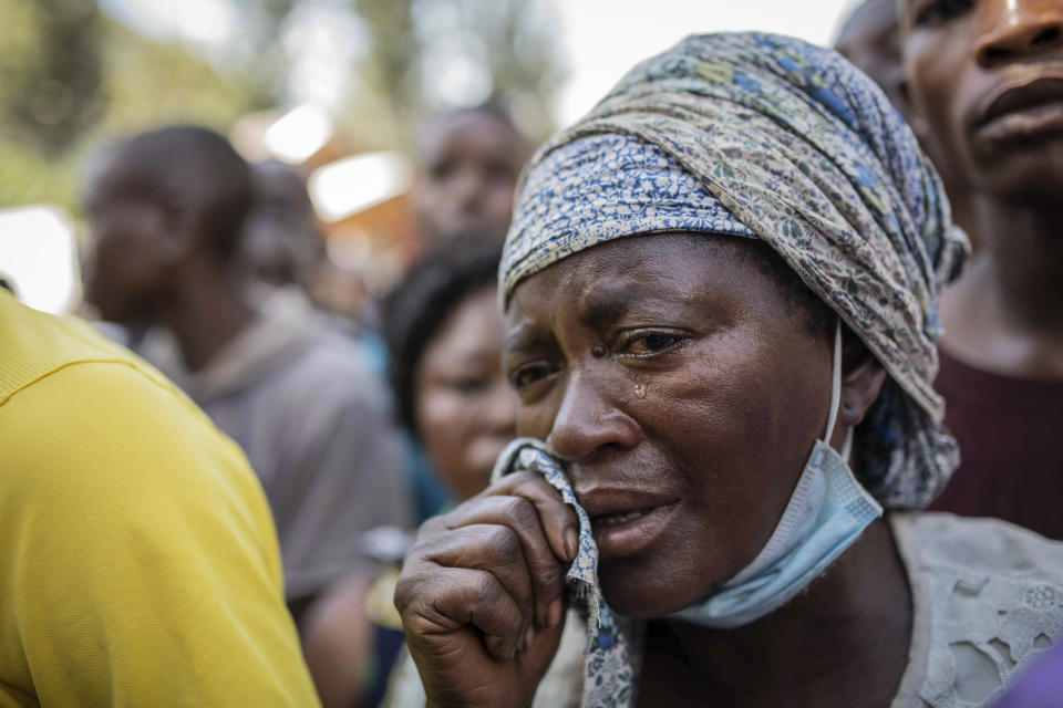 A woman with missing family members cries as she learns further bodies have been found on a nearby island, in the village of Nyamukubi, South Kivu province, in Congo, Saturday, May 6, 2023. The death toll from flash floods and landslides in eastern Congo has risen according to the governor and authorities in the country's South Kivu province. (AP Photo/Moses Sawasawa)