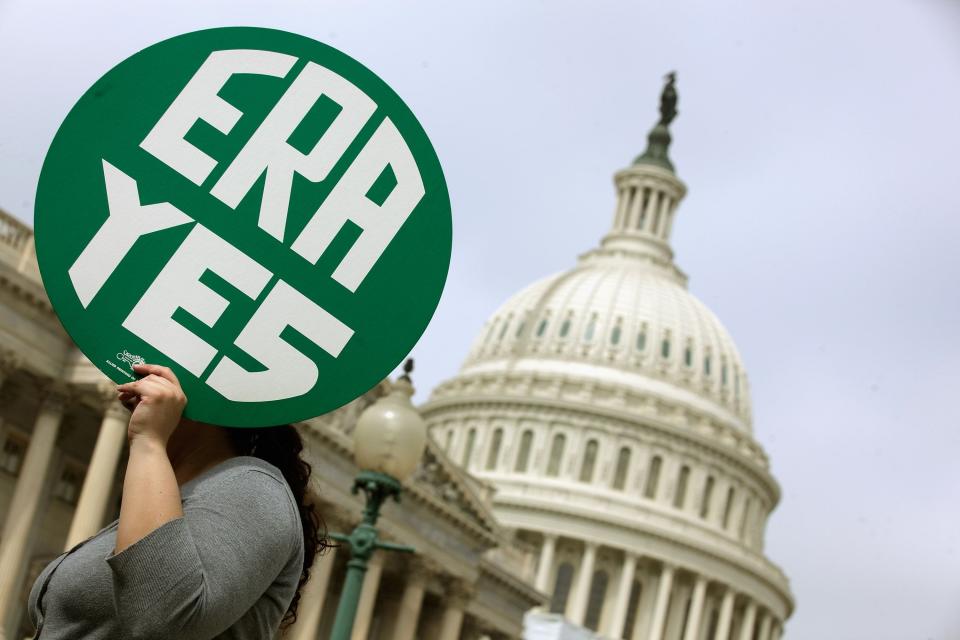 A woman holds up a sign as members of Congress and representatives of women's groups hold a rally to mark the 40th anniversary of congressional passage of the Equal Rights Amendment (ERA) outside the U.S. Capitol March 22, 2012 in Washington, DC.