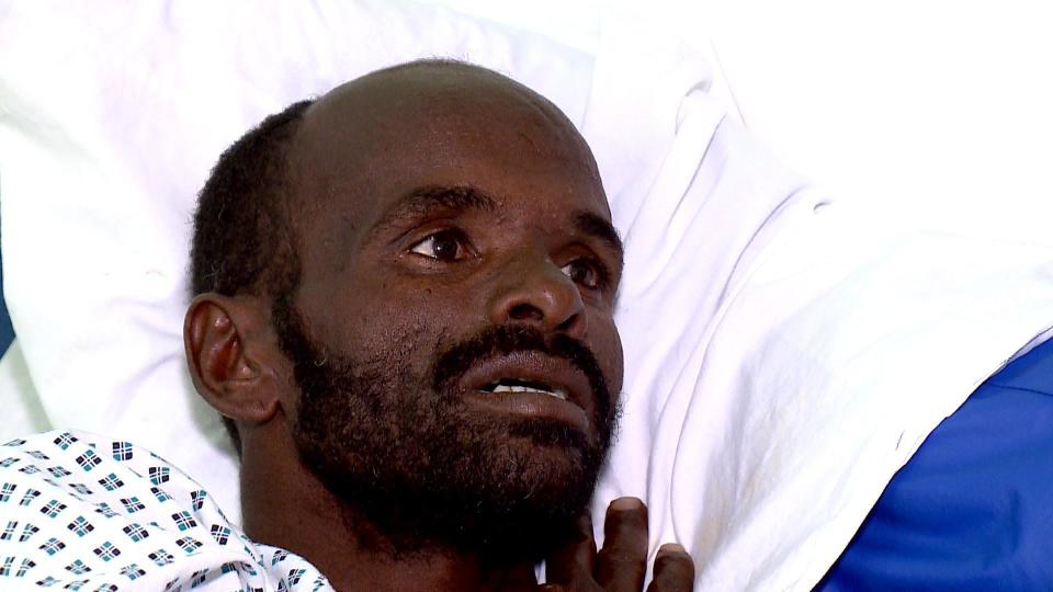 In this frame grab made available by the Malta TV, Mohammed Oga is interviewed at the Mater Dei hospital, Malta, Friday, Aug. 16, 2019. The European border agency Frontex on Monday spotted a rubber dinghy adrift with two people on board from one of their planes, while patrolling the central Mediterranean Sea. Mohammed Oga, the sole survivor, is a 38 years-old Ethiopian man. Interviewed the survivor in a Maltese hospital, he said he was traveling on the rubber dinghy with 14 more passengers who all died without food and water after being 11 days adrift. (Malta TV Via AP)