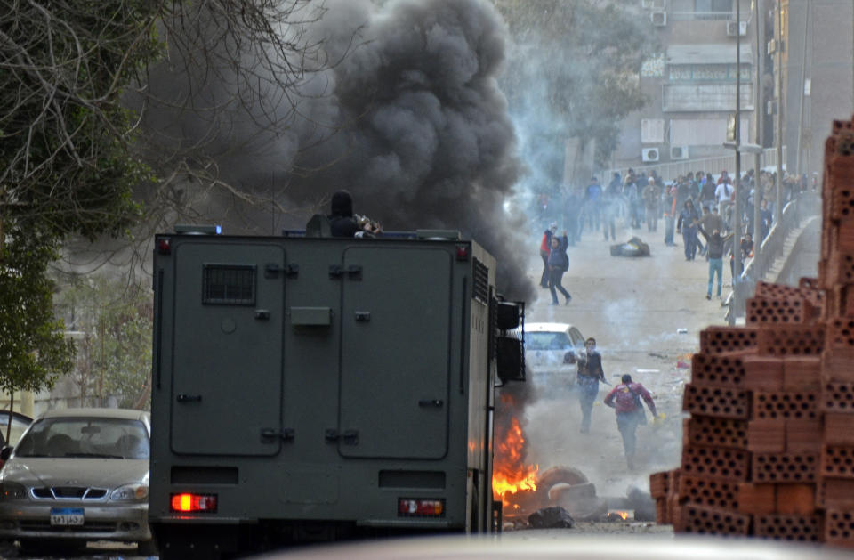 Egyptian security forces try to disperse supporters of Egypt's ousted President Mohammed Morsi protesting against the government in Cairo, Egypt, Friday, Jan. 31, 2014. Around the country, riot police firing tear gas clashed with hundreds of Morsi supporters protesting in Cairo, the Mediterranean coastal city of Alexandria and Fayoum, south of the capital. The Egyptian military also battled Islamic militants in the northern part of Sinai who have escalated a campaign of bombings and shootings in retaliation for last summer's army coup that ousted Morsi and for the ensuing crackdown against Islamists. (AP Photo/Mostafa Darwish)