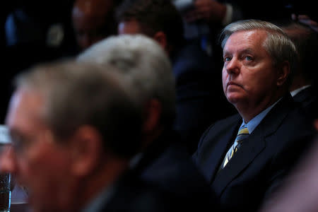 U.S. Senator Lindsey Graham (R-SC) listens as President Donald Trump speaks during a bipartisan meeting with legislators on immigration reform at the White House in Washington, U.S. January 9, 2018. REUTERS/Jonathan Ernst