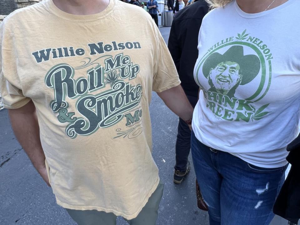 Two people wearing Willie Nelson concert T-shirts.