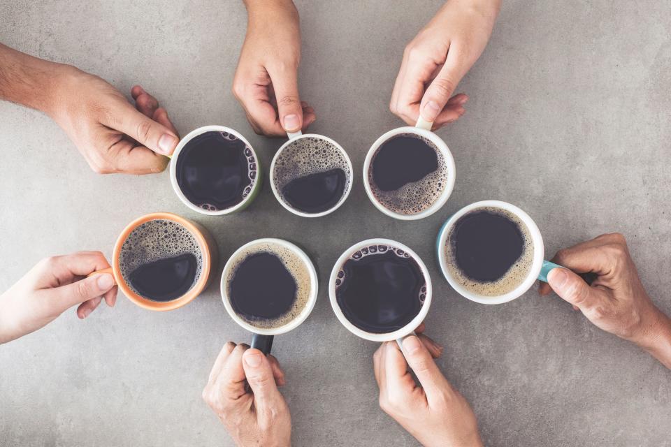 People holding cups of coffee