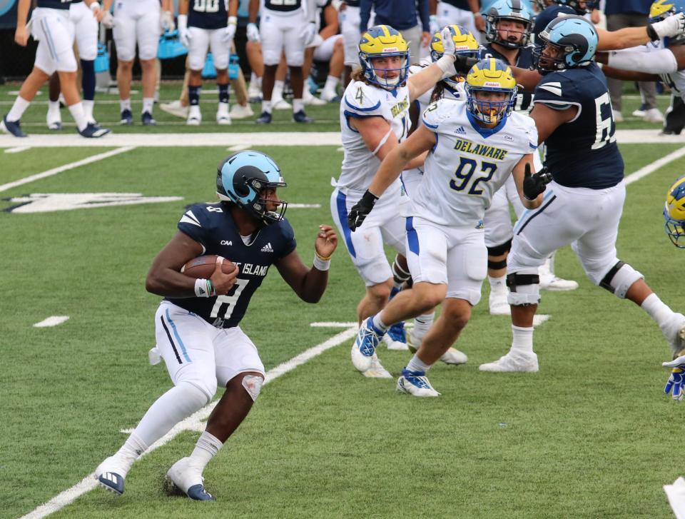 URI quarterback Kasim Hill, left, scrambles out of the pocket during a game against Delaware last October. The 2022 Rams have been ranked 22nd in the Stats Perform poll, which was released on Monday.