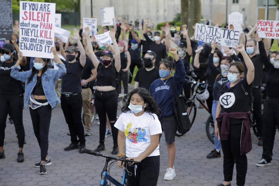 Protesters rally in Flushing Meadows Corona Park in the Queens borough of New York, Sunday, May 31, 2020. Demonstrators took to the streets of New York City to protest the death of George Floyd, a black man who was killed in police custody in Minneapolis on May 25. (AP Photo/Seth Wenig)