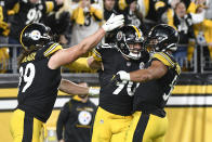 Pittsburgh Steelers outside linebacker T.J. Watt (90) celebrates with defensive end Henry Mondeaux (99) and outside linebacker Alex Highsmith (56) after he forced Seattle Seahawks quarterback Geno Smith (7) to fumble and inside linebacker Devin Bush (55) recovered the ball in overtime of an NFL football game, Sunday, Oct. 17, 2011, 2021, in Pittsburgh. The Steelers won 23-20 in overtime. (AP Photo/Don Wright)