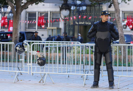 Police officers stand guard in front of the Ministry of the Interior during demonstrations on the seventh anniversary of the toppling of president Zine El-Abidine Ben Ali, in Tunis, Tunisia January 14, 2018. REUTERS/Zoubeir Souissi