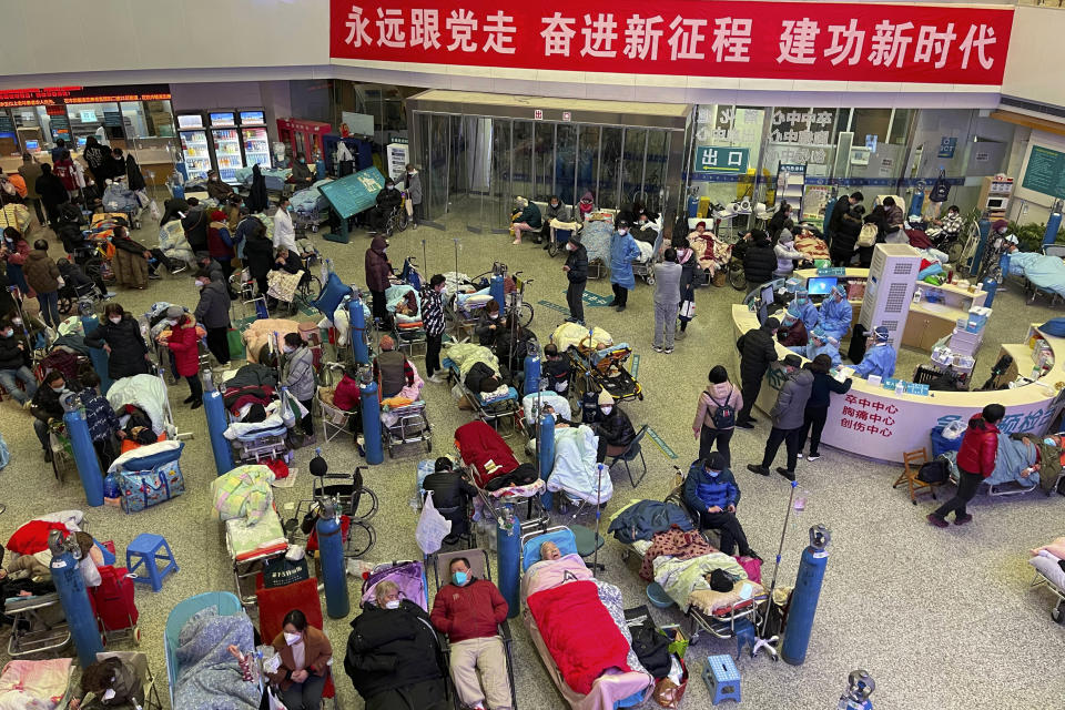 FILE - Patients, most of them elderly with COVID symptoms, are gathered at the Changhai Hospital hall as they receive medical treatment, in Shanghai, China, Jan. 3, 2023. China's sudden reopening after two years holding to a "zero-COVID" strategy left older people vulnerable and hospitals and pharmacies unprepared during the season when the virus spreads most easily, leading to many avoidable deaths, The Associated Press has found. (Chinatopix Via AP, File)