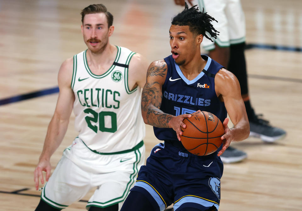 Memphis Grizzlies' Brandon Clarke (15) handles the ball as Boston Celtics' Gordon Hayward (20) defends during the second half of an NBA basketball game Tuesday, Aug. 11, 2020, in Lake Buena Vista, Fla. (AP Photo/Mike Ehrmann, Pool)