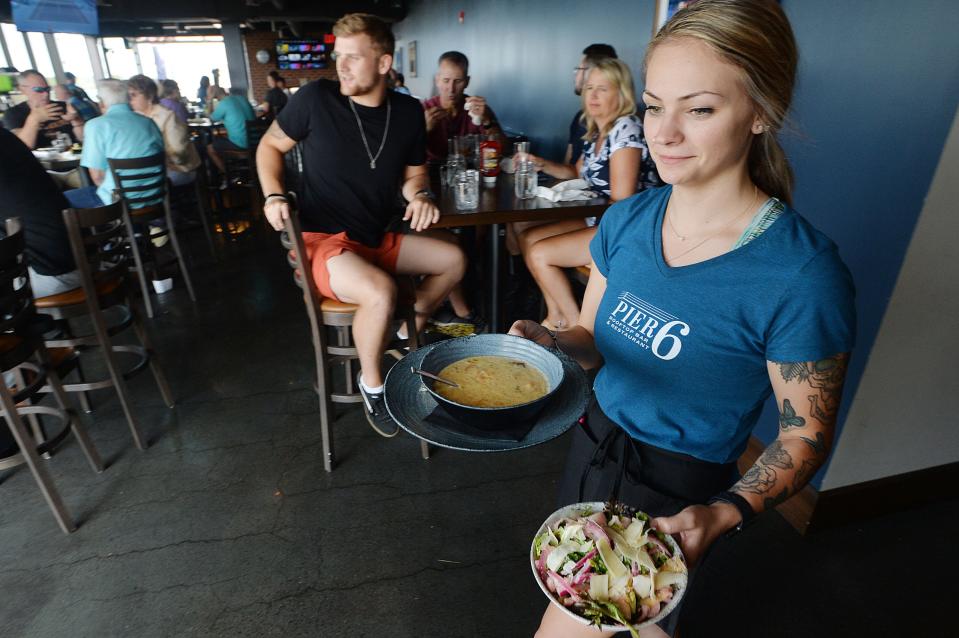 Pier 6 Rooftop Bar & Restaurant server Malyna Zboyovski, 20, delivers food to the dining room, which offers views of Presque Isle Bay.