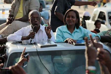 Former President Jean-Bertrand Aristide speaks beside presidential candidate Maryse Narcisse, of Fanmi Lavalas party, during a rally ahead of the presidential election, in a street of Port-au-Prince, Haiti, November 17, 2016. REUTERS/Andres Martinez Casares