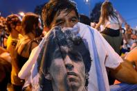 People mourn soccer legend Diego Maradona outside the morgue where his body is being held, in Buenos Aires