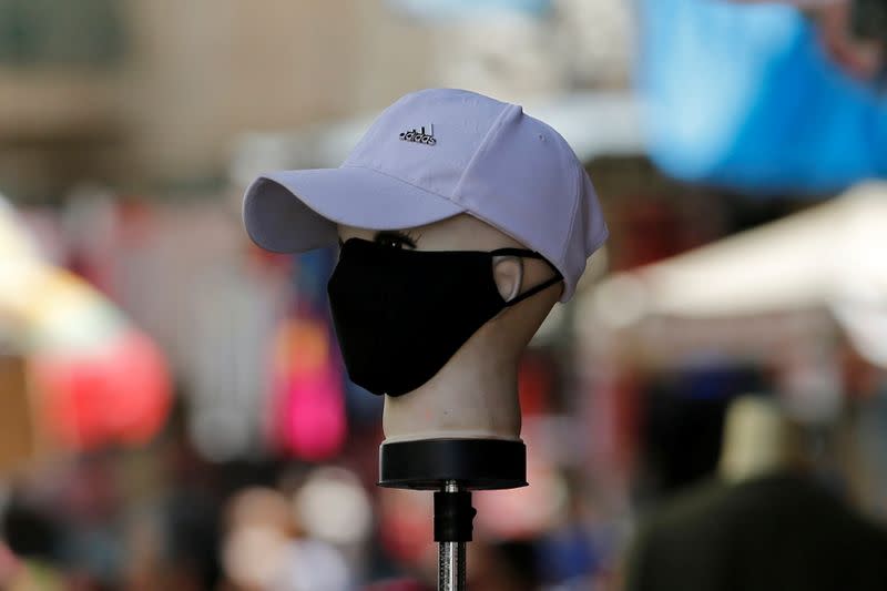 A mannequin wearing a protective face mask is seen at a market as Palestinians prepare for the upcoming holiday of Eid al-Fitr marking the end of Ramadan