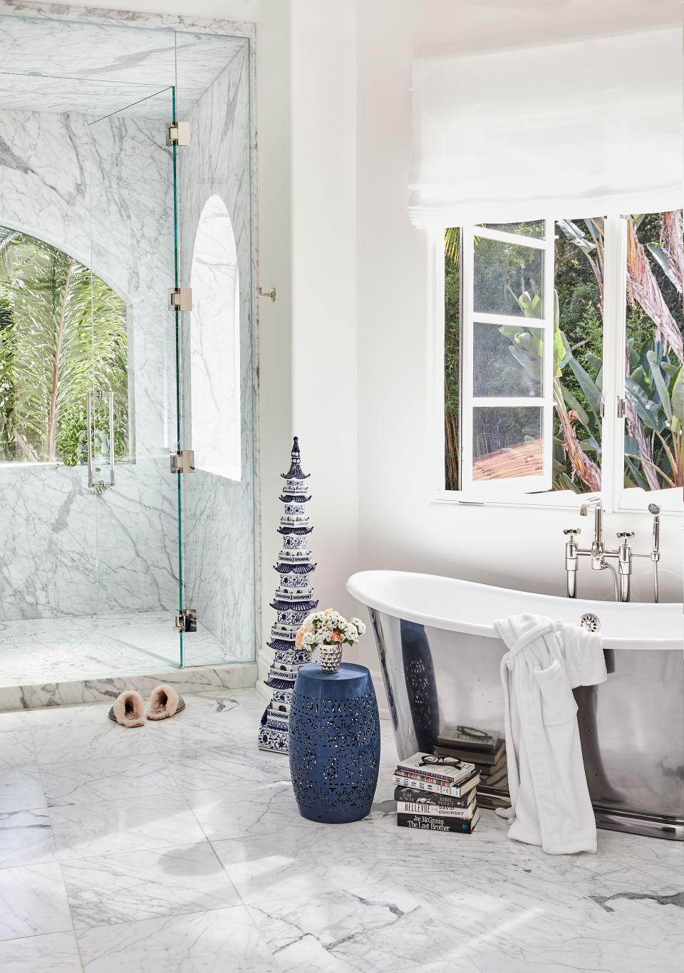 A bathing suite connects to a dressing room area. “The bathroom was very dark,” says Rivers of the remodel. “Dark floors, dark wood, no light, and so we brightened it all up.” The bathtub is from Drummonds (“I’m more of a shower person, but I love a good tub”), and the Chinese pagoda and garden stool were from her mother’s garden at her home in New Milford, Connecticut.