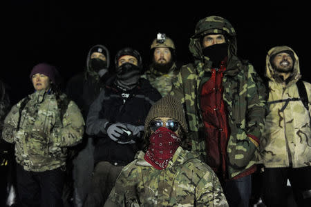 Veterans have a demonstration on Backwater bridge during a protest against plans to pass the Dakota Access pipeline near the Standing Rock Indian Reservation, near Cannon Ball, North Dakota, U.S., December 1, 2016. REUTERS/Stephanie Keith