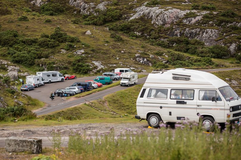 ULLAPOOL, SCOTLAND - JULY 28: Car parks and beauty spots along the A838 are busy as tourists take to the North Coast 500 route on July 29, 2020 in Ullapool, Scotland. Scotland has recently lifted the ban on holiday accommodation and up to 15 people can meet outdoors that was put in place to curb the spread of Coronavirus. North Scotland has seen an influx of camper vans and tourists. (Photo by Paul Campbell/Getty Images)