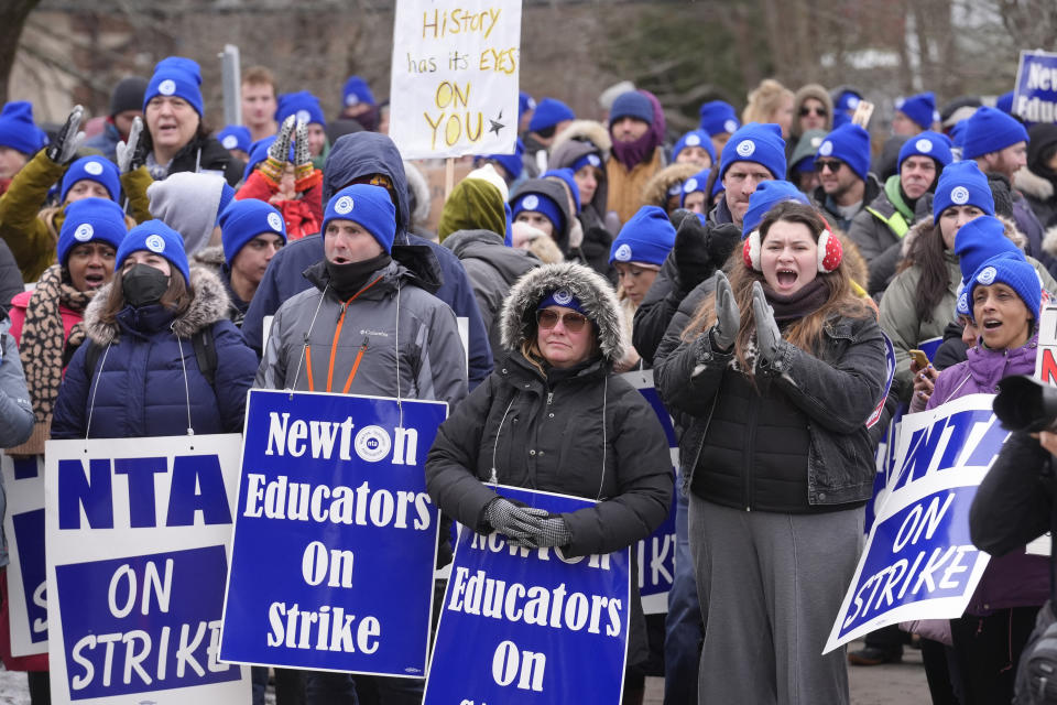 Striking Newton teachers and supporters display placards and chant during a rally, Tuesday, Jan. 30, 2024, outside Newton City Hall, in Newton, Mass. Contract negotiations between the Newton Teachers Association and the city's School Committee continued Tuesday. (AP Photo/Steven Senne)