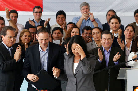 Peruvian presidential candidate Keiko Fujimori, accompanied by her husband Mark Villanella and elected congressmen, attends a news conference after Peru's electoral office ONPE said she lost against Pedro Pablo Kuczynski in the country's presidential election, at her party's headquarters in Lima, Peru, June 10, 2016. REUTERS/Mariana Bazo