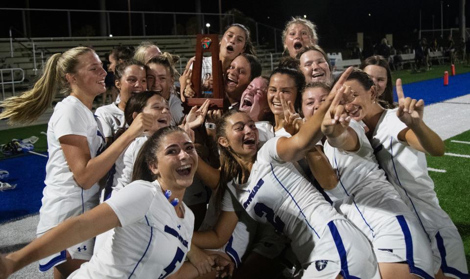 Members of the Community School of Naples Lacrosse team celebrates a district win over Naples at CSN on Thursday, April 18, 2024.