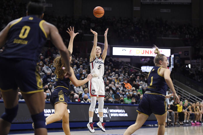 Connecticut's Paige Bueckers shoots over Notre Dame's Madelyn Westbeld (34) in the second half of an NCAA college basketball game, Sunday, Dec. 5, 2021, in Storrs, Conn. (AP Photo/Jessica Hill)