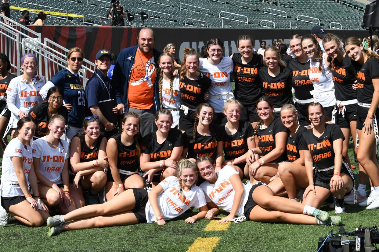 Ladies from the Notre Dame Academy flag football team pose for a photo at the girls flag football kickoff jamboree sponsored by USA Football and the Cincinnati Bengals at Paycor Stadium, Sept. 30, 2023.
